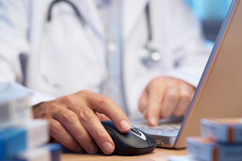 Doctor preparing online internet prescription selective focus
