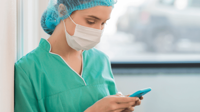 female doctor using mobile phone